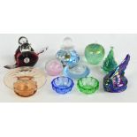 A small group of glass paperweights to include a carnival glass example modelled as a Native