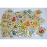 A collection of 1930s Kensitas silk cards embroidered with floral motifs, in various sizes.