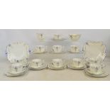 A Shelley floral decorated tea service comprising eleven cups of square form with canted corners
