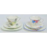 A Shelley landscape decorated trio in the US/2121/26 pattern and a further Shelley floral decorated