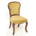 A mahogany button upholstered spoon back dining chair with cabriole legs.