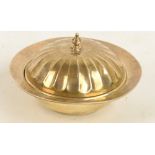 A George V hallmarked silver circular muffin dish and cover with gadrooned decorated cast finial,