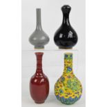 A Chinese powder red glazed vase of slender baluster form with ribbed neck and flared rim and with