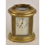 A miniature 20th century brass oval carriage clock,