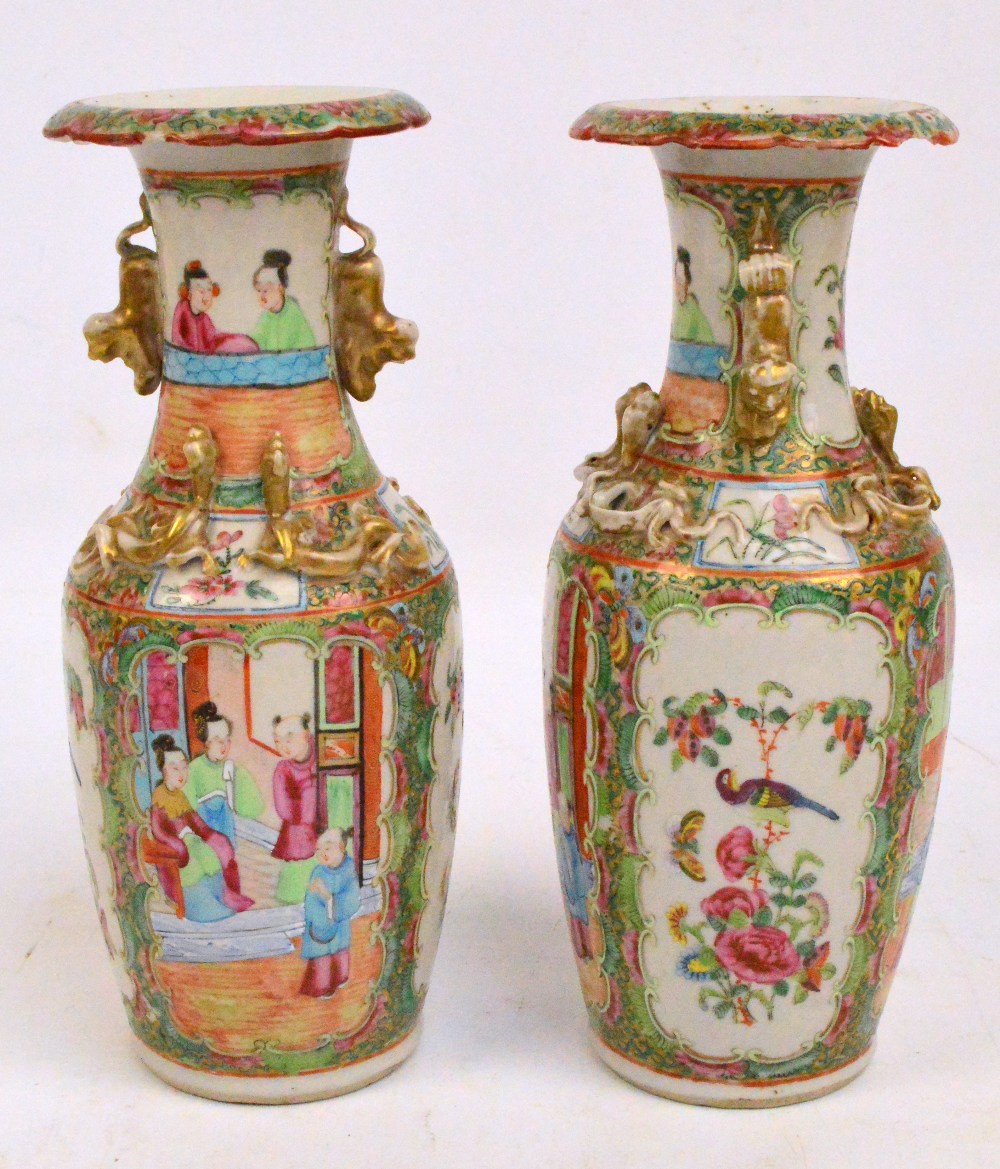 A near pair of 19th century Canton baluster vases with flared rims,
