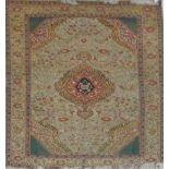 A beige carpet with central ornamental medallion with floral decorated ground within a similar