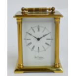 A small brass striking carriage clock with bevelled glass and small top panel,