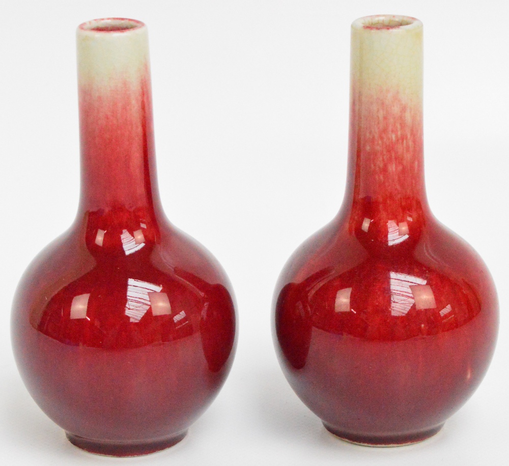 A pair of small 20th century Chinese porcelain sang-de-boeuf and crackle glazed bottle vases,