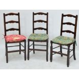 A set of three ladder back rush seated chairs (3).