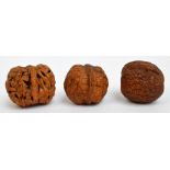 Three early 20th century carved walnut shells,