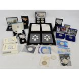 A collection of various British silver proof coins to include two sets of United Kingdom coinage