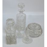 A group of clear cut glass items comprising a cylindrical decanter, a squat jar and cover,