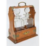 An Edwardian oak and silver plated two bottle tantalus,