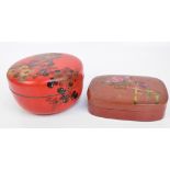 A large Japanese lacquer circular box and cover painted with floral sprays,