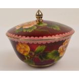 A 20th century Japanese red ginbari circular pot and cover decorated with blossoming sprays to the