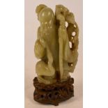 A fine Chinese 18th/19th century carved jade figure of Shou Lao leaning on a staff beside pine