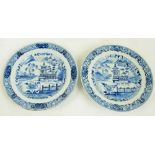 A pair of early 19th century Chinese blue and white painted plates decorated with a pagoda in