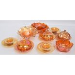 A group of orange carnival glass items to include a comport,