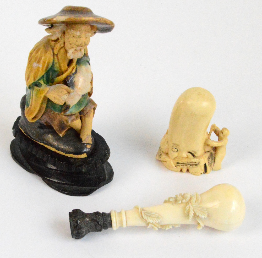 A Japanese Meiji period carved ivory netsuke, height 5cm, a carved ivory seal with white metal cap,