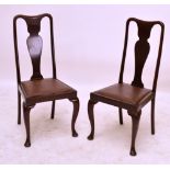 A set of four early 20th century mahogany Queen Anne style dining chairs raised on cabriole legs