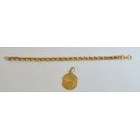An Italian 18ct yellow gold circular pendant with Zodiac symbol and a 9ct gold bracelet (clasp af),