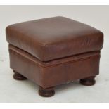 A brown leather pouffe