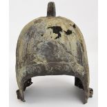 A Chinese Western Zhou Dynasty style bronze helmet with stud decorated D-shaped openings,
