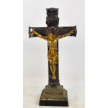 A late 19th century white metal crucifix with gilt Corpus Christi on square stepped base and