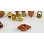 A collection of fourteen 19th century and later ojime beads including fruit pits, amber, brass, etc,