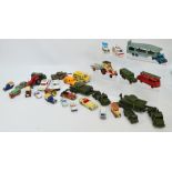 A collection of play worn diecast vehicles including Dinky tanks, tank carriers, army ambulance,