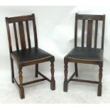 A pair of oak chairs with upholstered seats on turned front legs with stretchers.