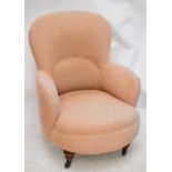 A late Victorian pale pink upholstered easy chair.