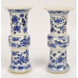 A near pair of 19th century Chinese porcelain Gu vases each painted in underglaze blue with birds,