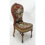 A Victorian walnut framed floral upholstered and beadwork decorated side chair raised on turned
