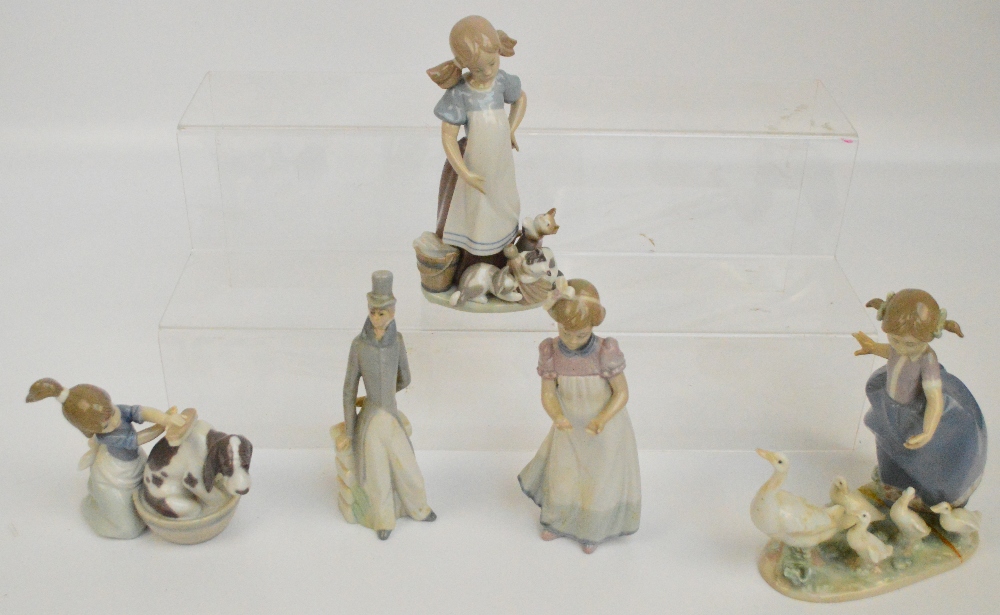 Four Lladro figures; a girl with geese, a girl washing a dog, a girl with kittens (af),