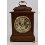 An early 19th century mahogany eight day mantel clock with brass mounts and feet,