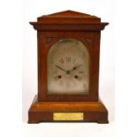 An early 20th century oak cased mantel clock,