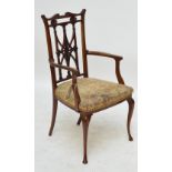 An Edwardian mahogany open arm elbow chair.