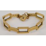 A 9ct yellow gold open and bar link bracelet with heart shaped padlock and safety chain, approx 15.