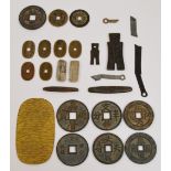 A collection of various predominantly bronze ancient Chinese and Japanese money tokens to include