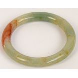 A Chinese polished jade bangle with slight russet inclusions, external diameter 8.2cm, approx 61.2g.