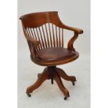 An early 20th century oak revolving desk chair.