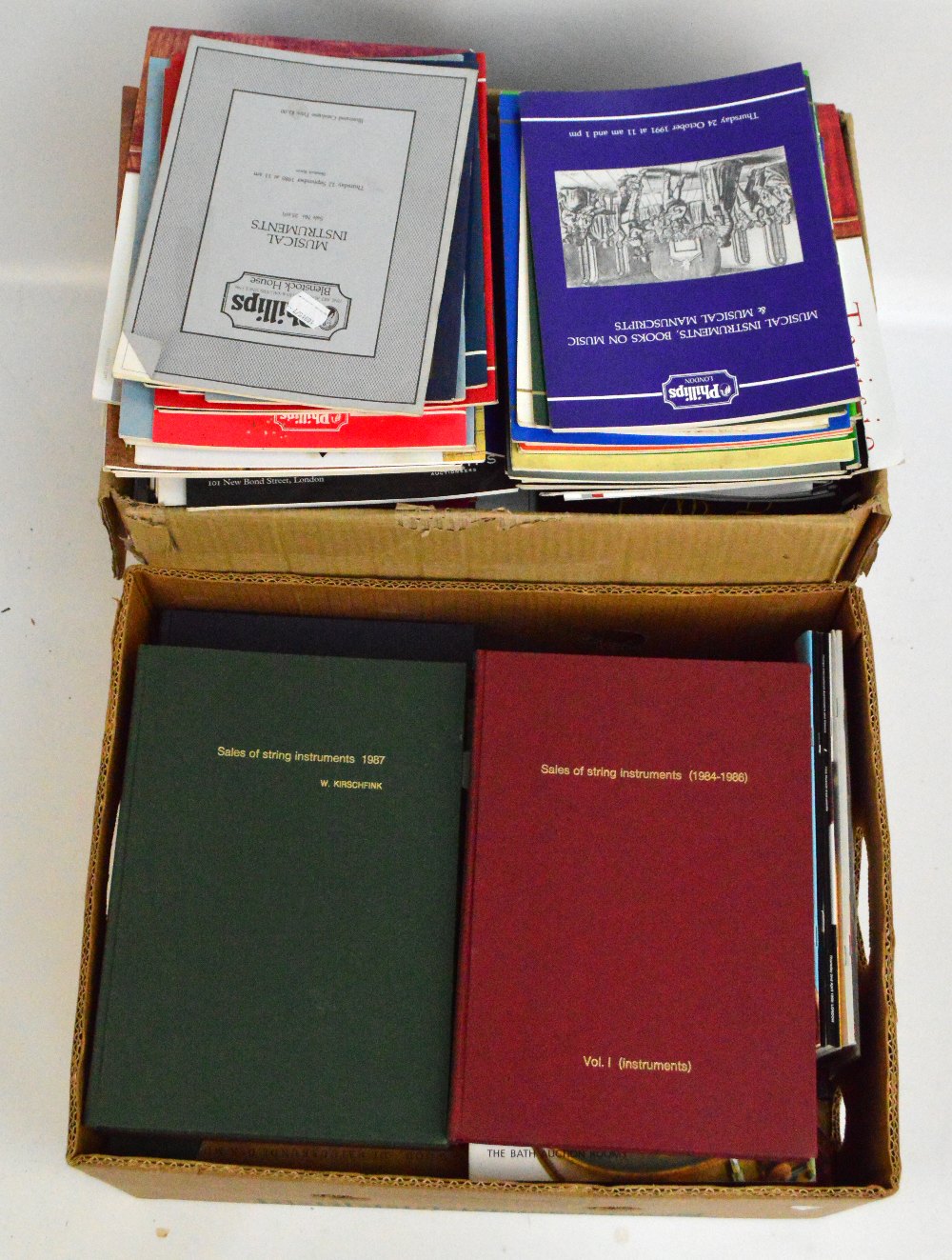 A collection of books and auction catalogues relating to musical instruments,