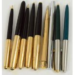 Two Parker fountain pens with gold rolled caps, two matching propelling pencils and a ballpoint pen,