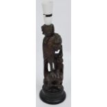 A Japanese Meiji period carved rootwood figure of a stylised bird upon a rock converted to a lamp,