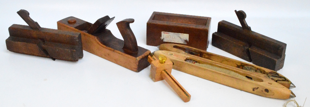 Two moulding planes, a large plane, a scribe, a small box with slotted top, and two loom shuttles.