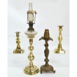 A brass candlestick with associated glass oil lamp upper section, height including funnel 43.