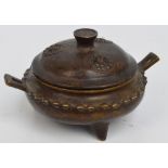 A 20th century Chinese bronze circular twin handled censer and cover with finial set with yin yang