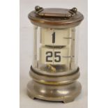 An early to mid 20th century ticket clock of cylindrical form with swing loop handle and bracket