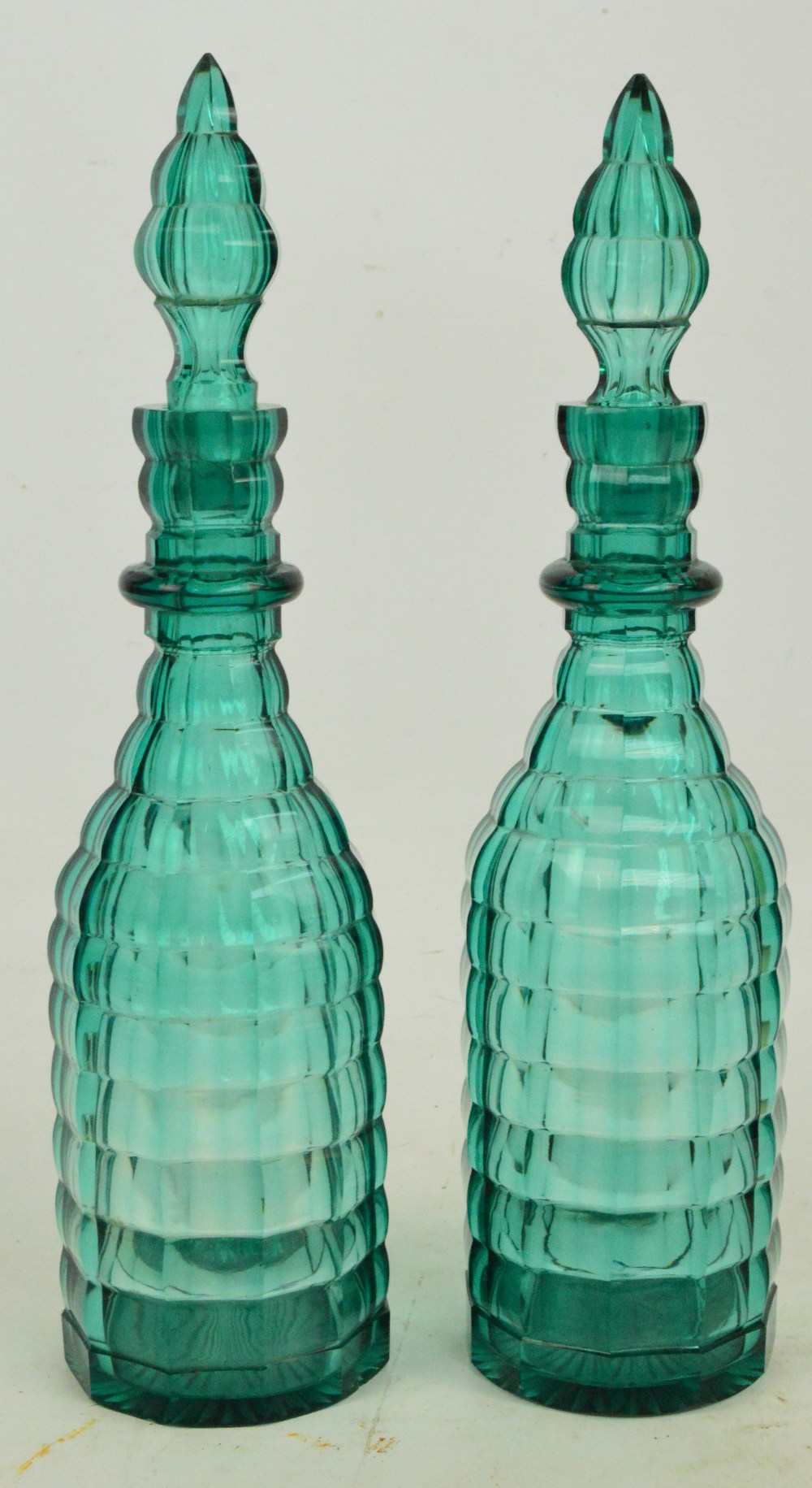 A pair of 19th century green glass single ring neck panel sided decanters, height 35cm.